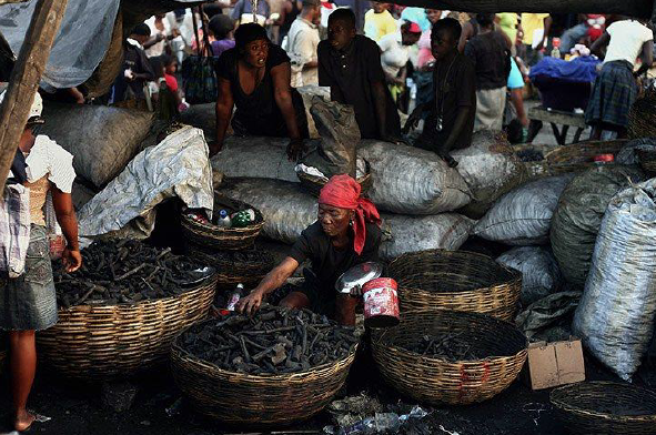 A charcoal vendor prepares for customers in the Petion Ville neighbourhood of Port-au-Prince. Picture: Hector Retamal